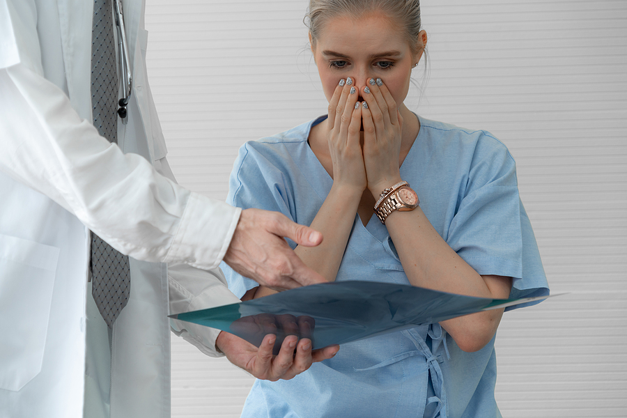 nurse reviewing error in medical client's chart