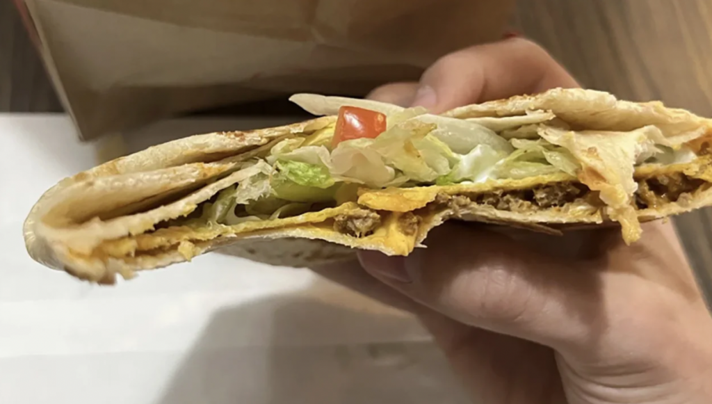 Photo of crunchwrap supreme from taco bell from customer showing lack of ingredients and messy - taco bell class action lawsuit