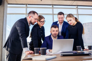  group of plaintiffs working together with a lawyer on a computer, representing the benefits of joining a mass tort lawsuit