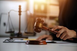 A judge's gavel rests on a table in a lawyer's office, symbolizing fair and ethical decision-making in court cases. The gavel is ready for use.