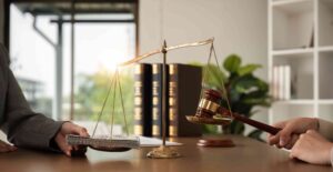 Scales of justice balancing gavel and money stack symbolizing legal judgment and financial settlement in law.