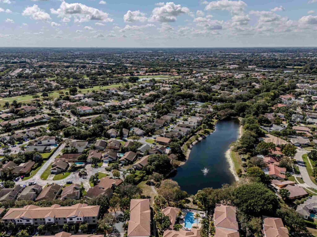 An aerial view of a Boca Raton residential neighborhood and community lake, highlighting the local geographic service area for Discord abuse lawsuits.