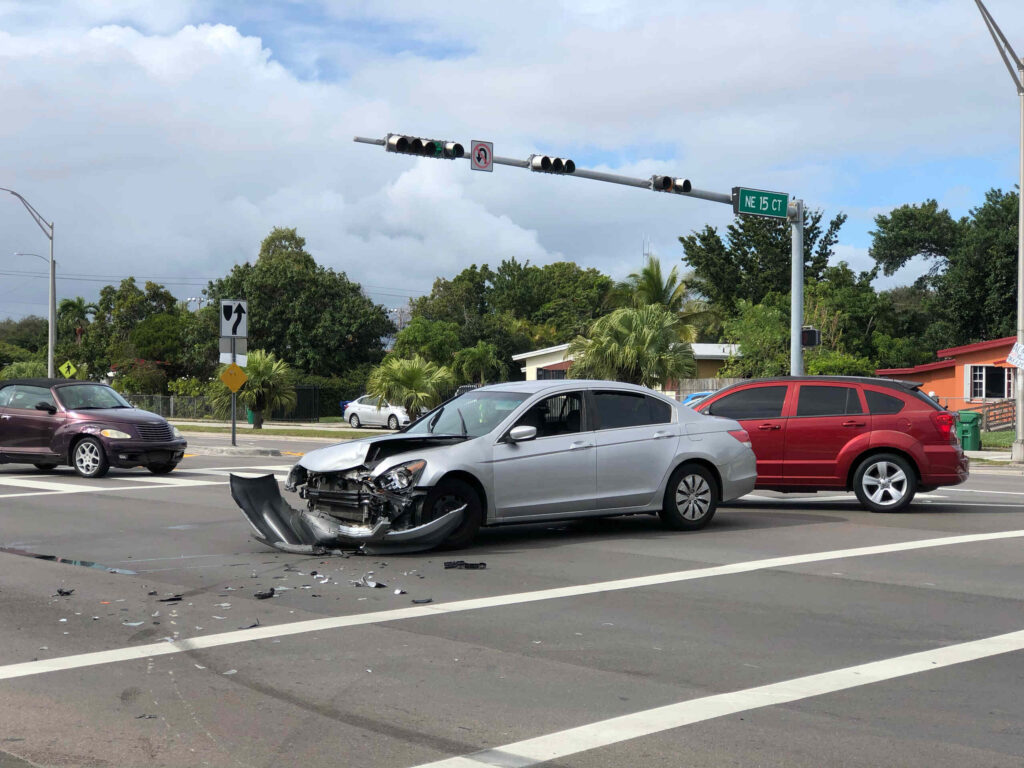 Damaged vehicles at an intersection crash scene, showing rideshare accident evidence to collect in Boca Raton.