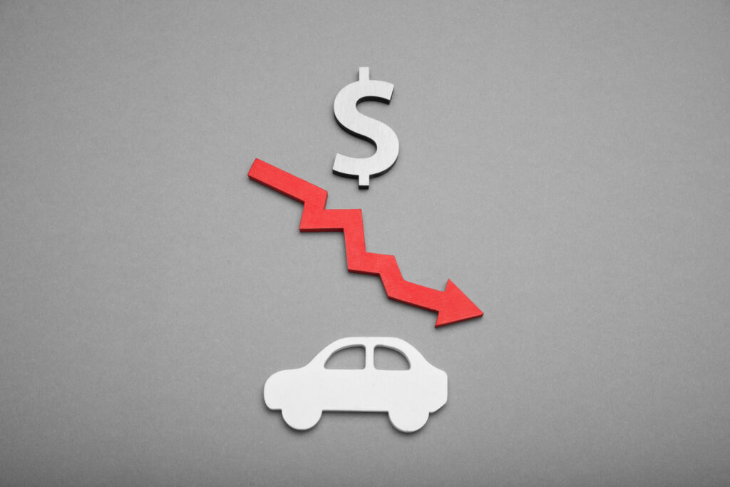 A downward arrow and dollar sign above a car cutout representing Florida diminished value and loss of use claims.