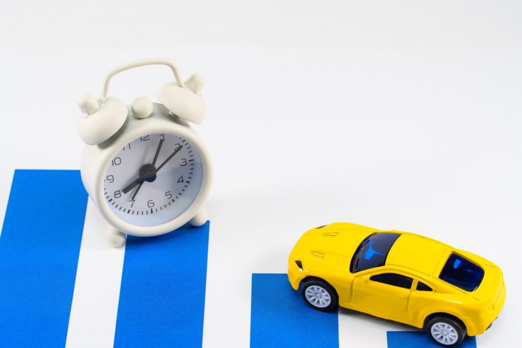 An alarm clock next to a toy car symbolizing rental time loss in Florida diminished value and loss of use claims.