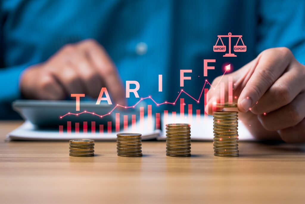 Stacked coins and a financial graph showing customs duty costs managed by trade and tariff refund attorneys.