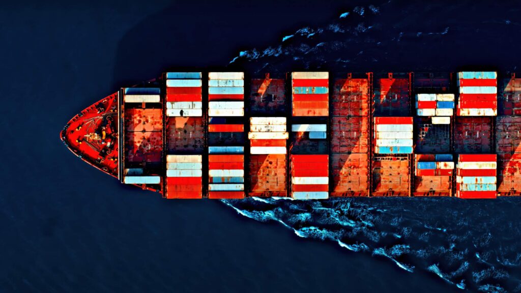 An aerial view of a cargo ship transporting international goods evaluated by trade and tariff refund attorneys.